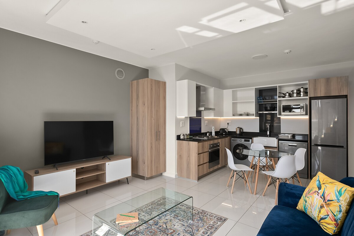 Furnished apartment living room with a television, sofas and dining table